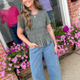 Woman standing outside a store with floral decorations
