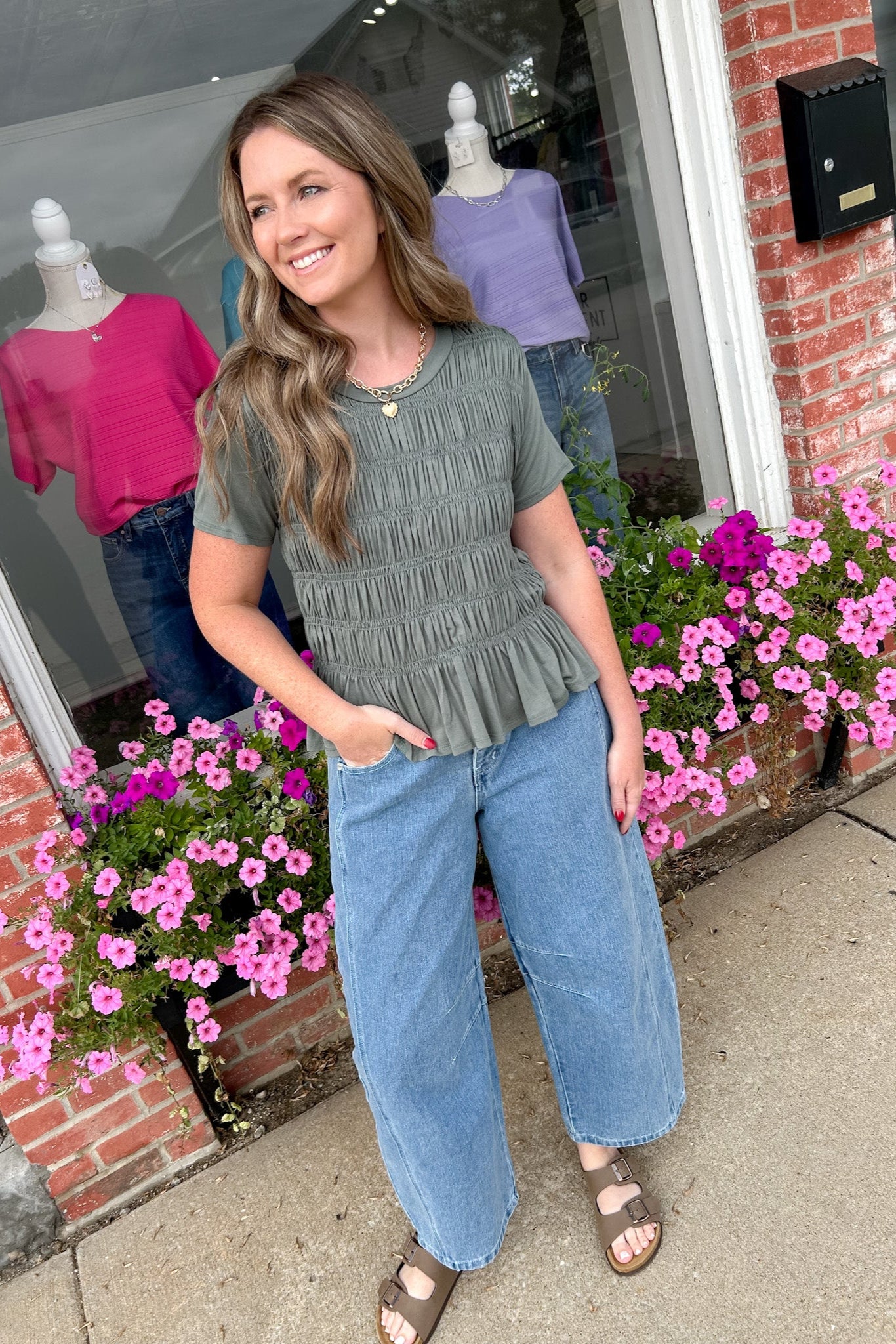 Woman standing outside a store with floral decorations