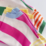 Colorful striped sweaters on a white background