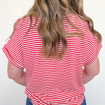 Person wearing a red and white striped shirt with blue jeans on a white background
