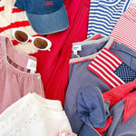 Collection of clothing and accessories with American flag designs on a white surface