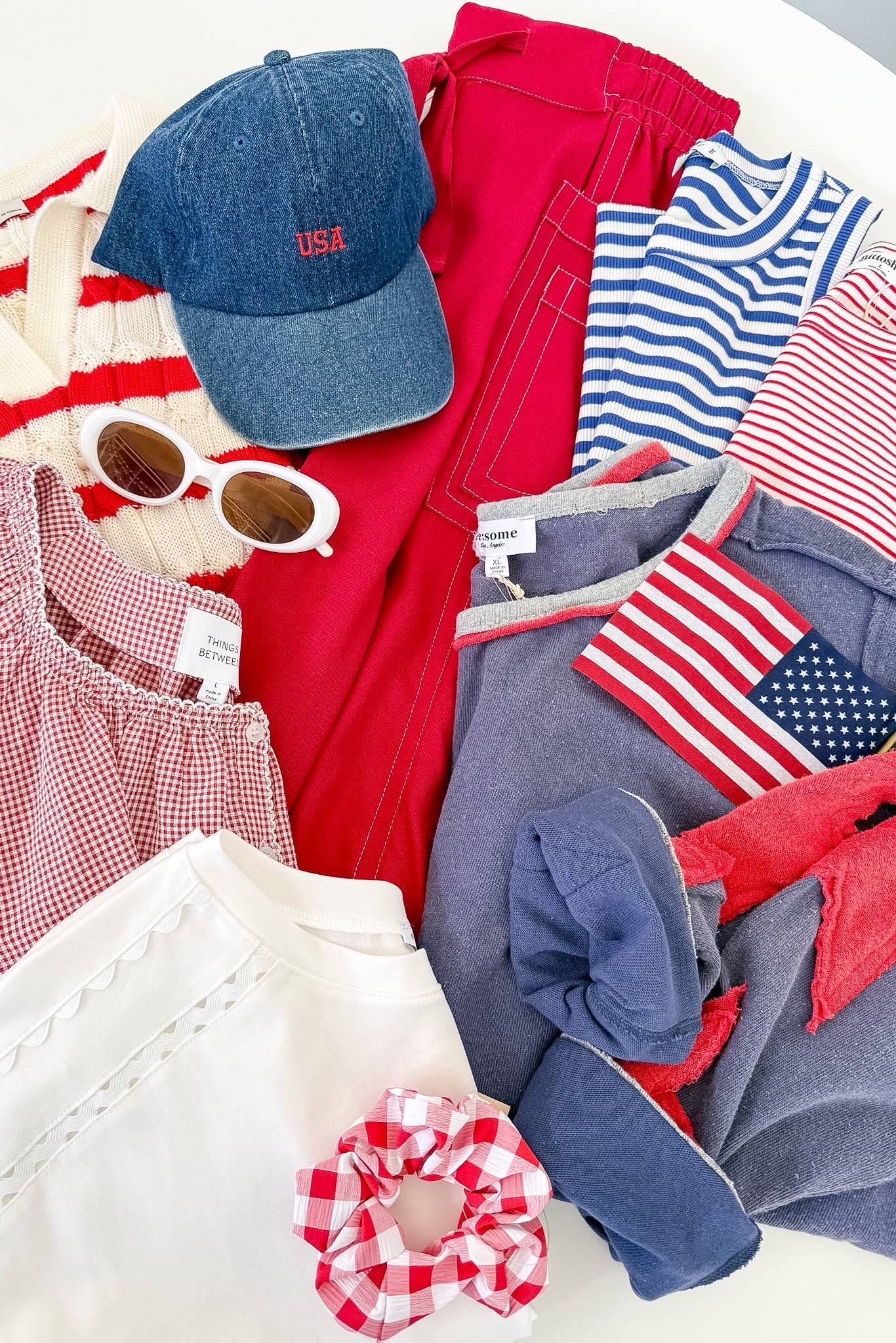 Collection of clothing and accessories with American flag designs on a white surface