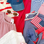 A pile of clothes that are red, white, and blue in color.