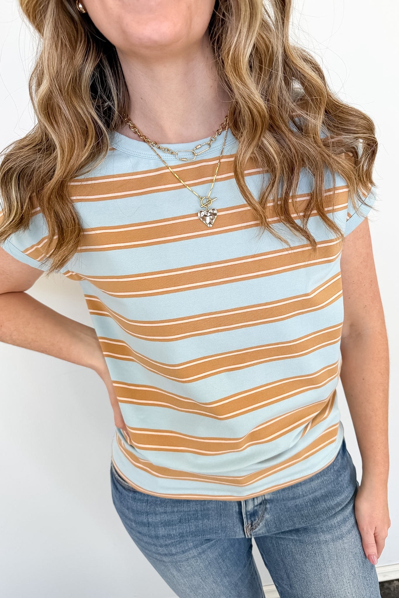 Person wearing a striped shirt with a plain background