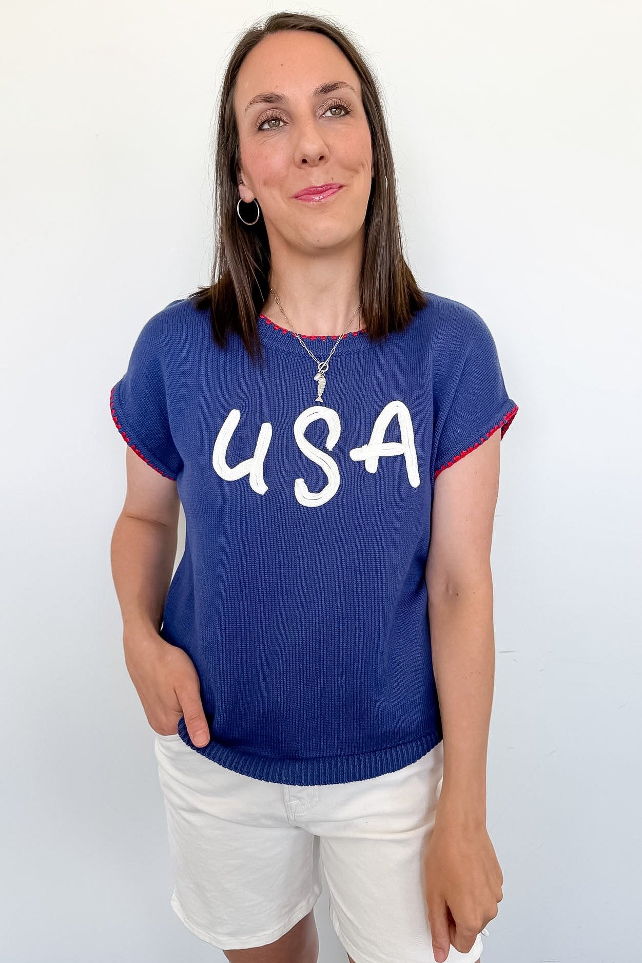 Woman wearing a blue 'USA' t-shirt against a white background