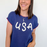 Woman wearing a blue sweater with 'USA' text against a white background