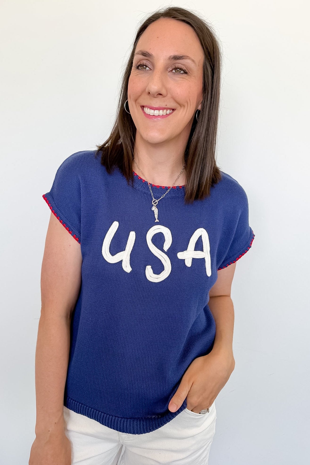 Woman wearing a blue sweater with 'USA' text against a white background