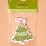 Christmas tree-shaped air freshener in packaging on a beige background