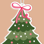 Decorative Christmas tree ornament with a pink bow on a beige background