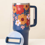 Floral-patterned mug with a blue handle on a white background
