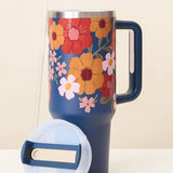 Floral-patterned mug with a blue handle on a white background