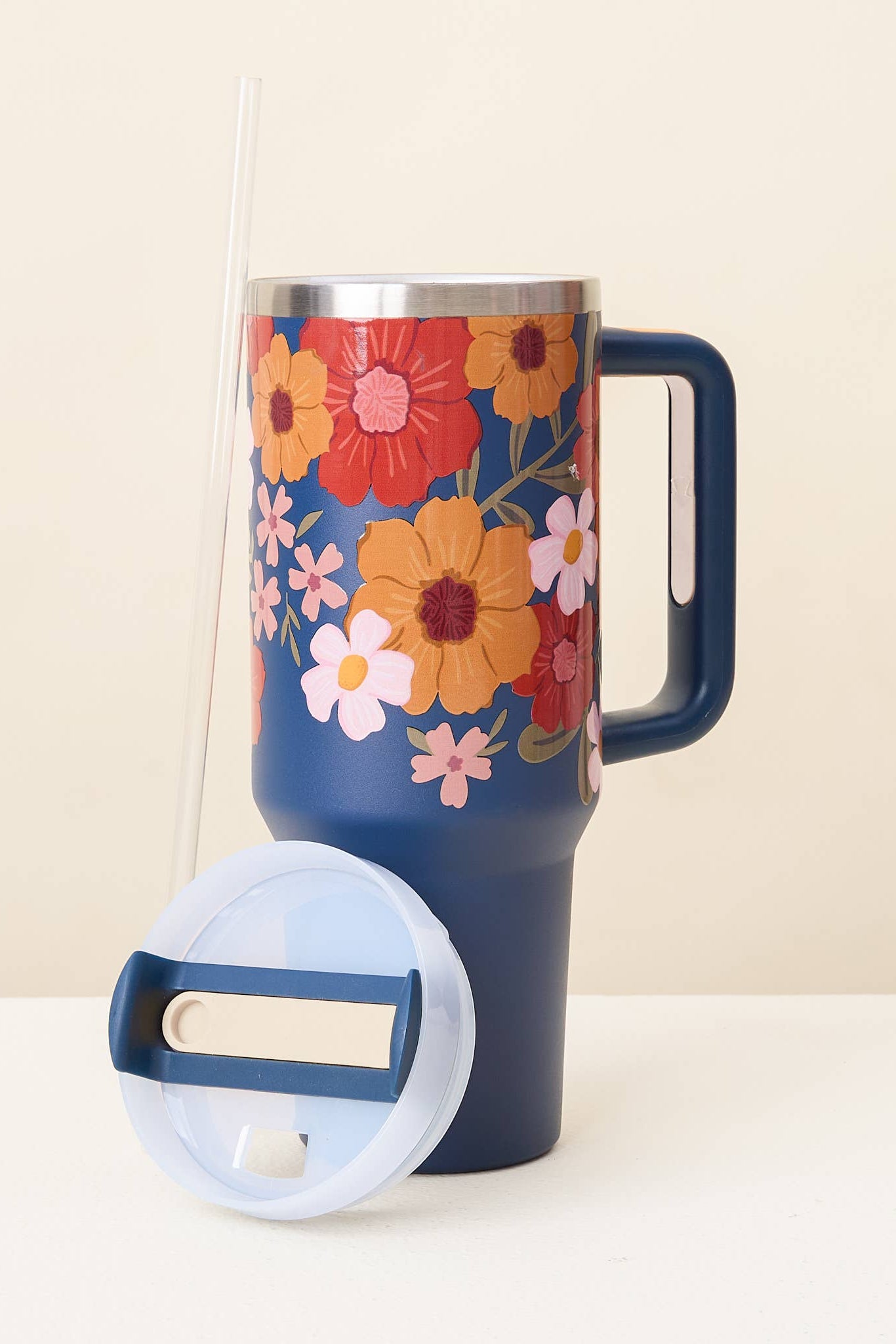 Floral-patterned mug with a blue handle on a white background