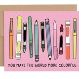 Card with colorful pens and crayons on a pink background, featuring text 'You make the world more colorful'.