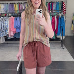 Woman wearing a striped tank top and shorts that coordinate.