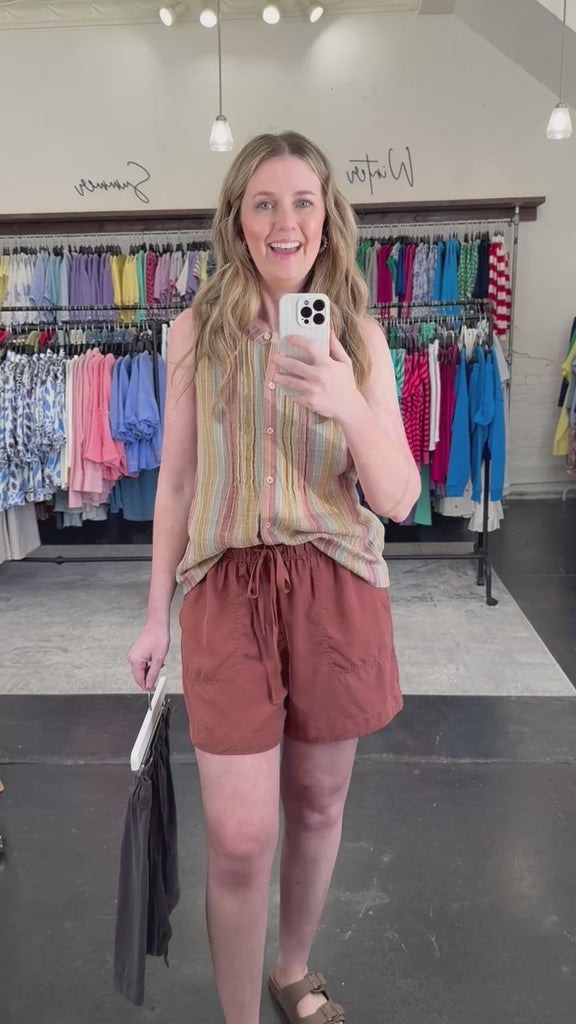 Woman wearing a striped tank top and shorts that coordinate.
